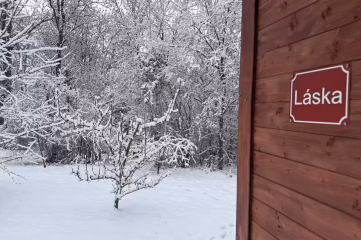Cabin of Love wrapped in snow, dark retreat in winter